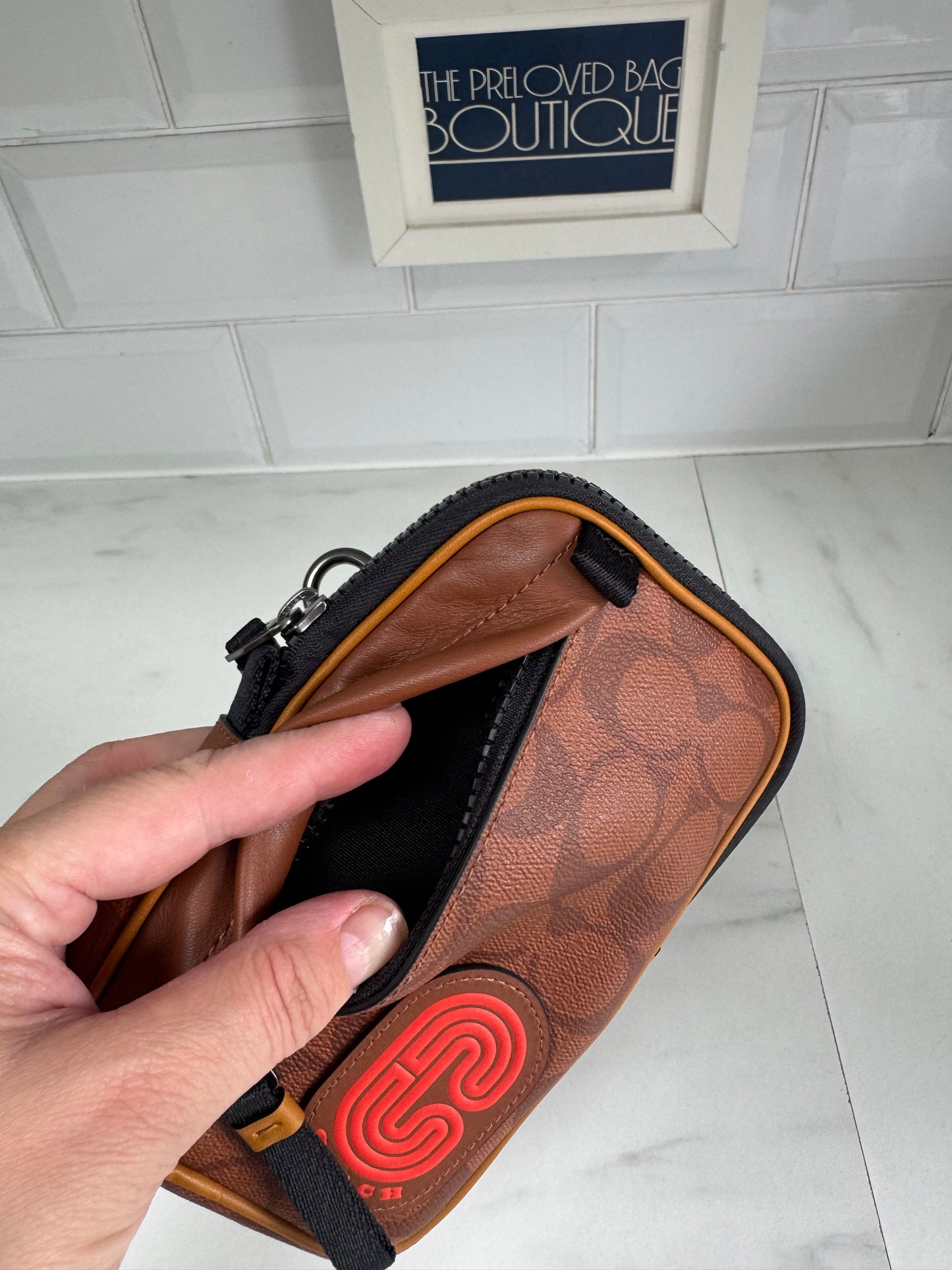 Coach North/South Hybrid Pouch in Signature Canvas - brown and red