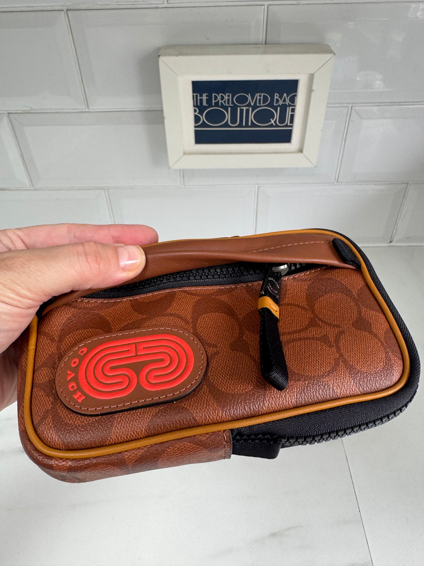 Coach North/South Hybrid Pouch in Signature Canvas - brown and red
