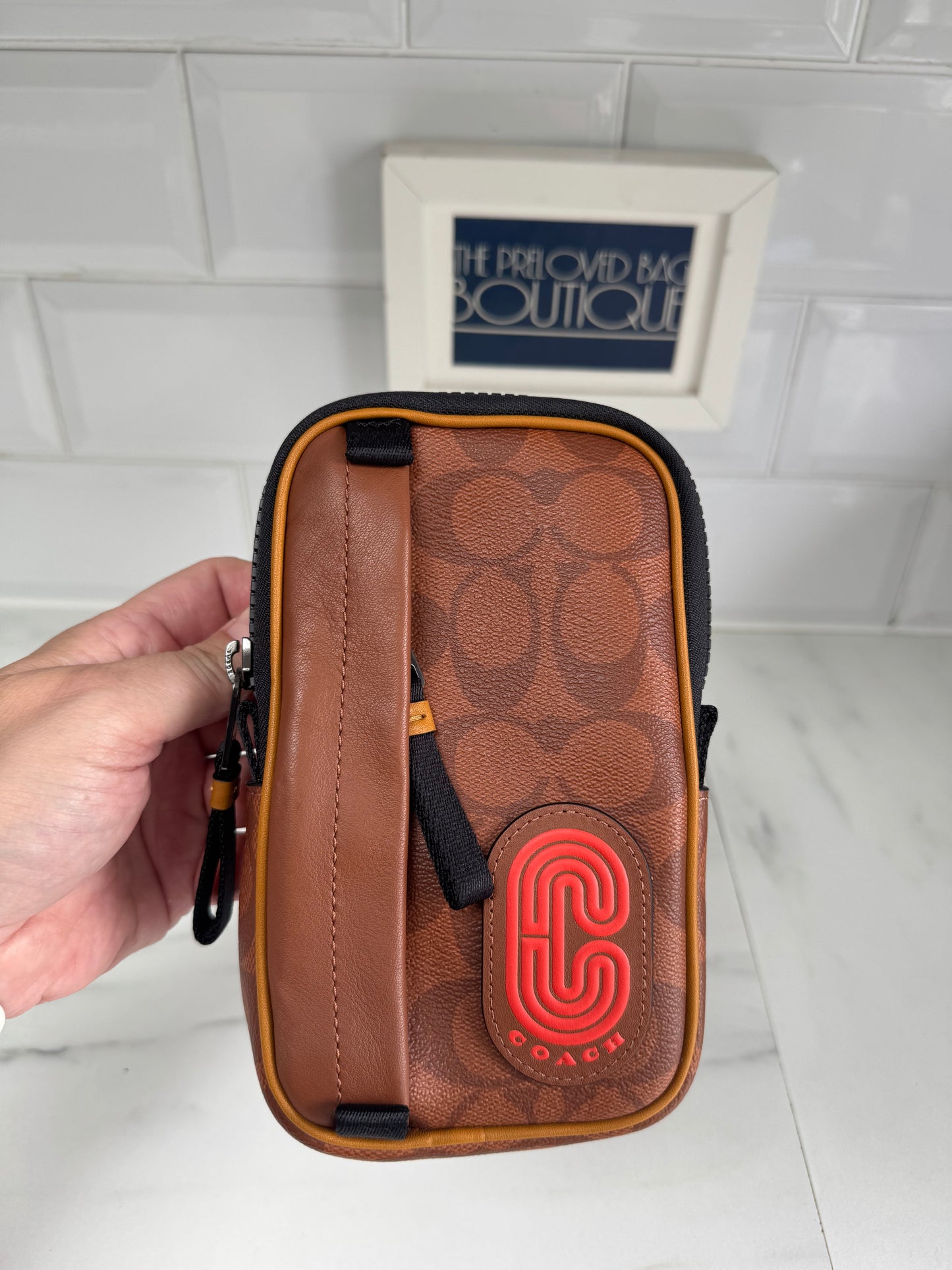 Coach North/South Hybrid Pouch in Signature Canvas - brown and red